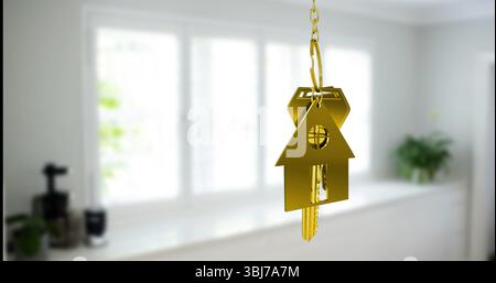Gold house-shaped keychain with keys hanging in kitchen beside coffee maker and plants, copy space Stock Photo