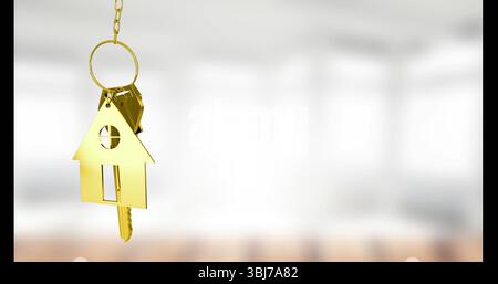 Hanging gold keychain featuring house-shaped fob and single key inside bright room, copy space Stock Photo