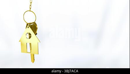 Displaying gold house-shaped keychain pendant with two gold keys against white backdrop, copy space Stock Photo