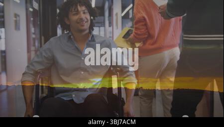 Interacting wheelchair user using yellow folder and smartphone in office corridor, with glass doors Stock Photo
