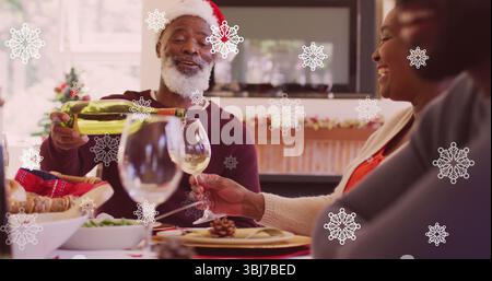 Host in Santa hat and sweater pouring white wine in living area, with green bottle, decorations Stock Photo
