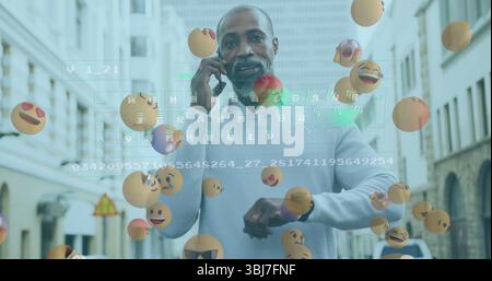 Talking man holding smartphone and checking watch on street, with floating emojis and code overlay Stock Photo