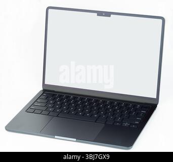 Sleek laptop features minimalist design with full keyboard and large screen, perfect for work or study. Stock Photo