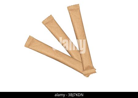 Three sugar in kraft paper sticks is isolated on white background. Stock Photo