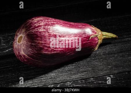 marble eggplant on black wood background Stock Photo
