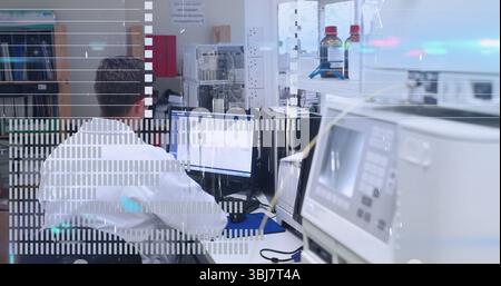 Operating lab technician wearing lab coat analyzing data on dual monitors at lab bench, copy space Stock Photo