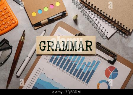 Text GRAMMAR made of wooden cubes and different words on white background. Concept of studying English Stock Photo
