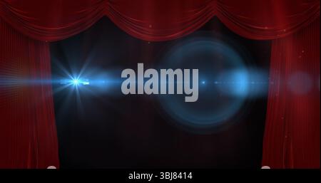 Revealing stage opening under blue spotlight with lens flare at theater, red velvet curtains Stock Photo