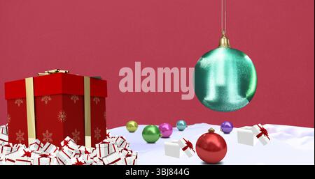 Displaying red gift box with gold ribbon in studio, white gift boxes, colorful baubles, copy space Stock Photo