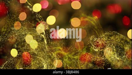 Swirling golden particle waves flowing across digital canvas stage, with warm yellow and red bokeh Stock Photo