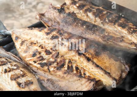 Grilled mackerel fish fillets on the grill. Close-up. Stock Photo