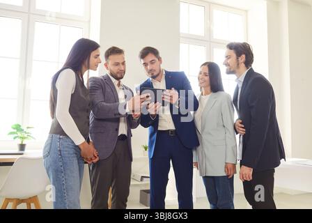 Focused serious business man team leader, coach mentoring, talking to diverse business people Stock Photo