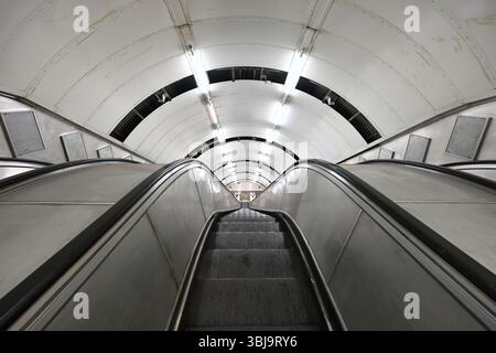 Looking down an escalator inside the disused section of Charing Cross tube station - part of a Hidden London tour Stock Photo