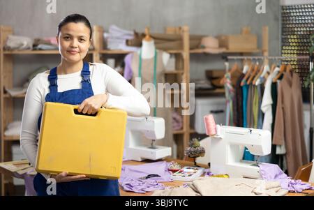 Woman sewing machine repairman standing in workshop Stock Photo