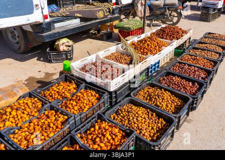 Morocco - October 29, 2024: Various types of dried dates in the boxes at a market stall that are for sale in Morocco. Stock Photo