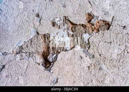 Crumbling plaster on the old wall. Stock Photo