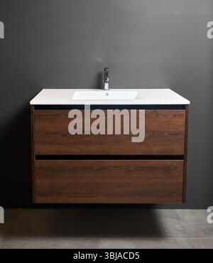 Walnut Bathroom Vanity with Ceramic Sink with one faucet hole, Large Storage Floating Bathroom Vanity for Modern Bathroom. Interior with wall hung van Stock Photo