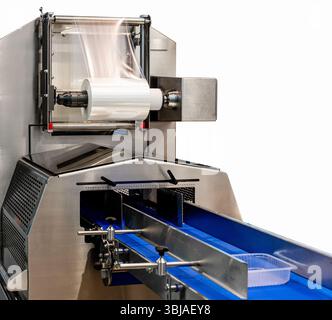 Isolated food packaging machine with rolled plastic film Stock Photo