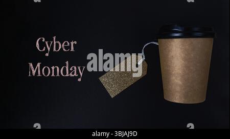 Coffee cup with a golden tag hanging from it with the words Cyber Monday Stock Photo
