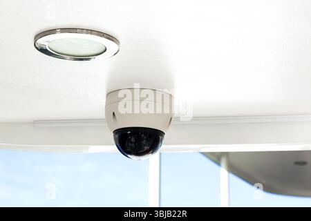CCTV camera on the hull of an expensive motor yacht. CCTV camera white on a white body. Stock Photo