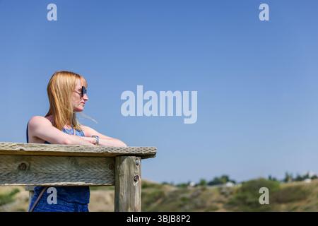 A woman standing at a viewpoint in the Old Man River Valley in Lethbridge Stock Photo