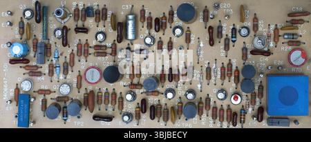 Close-up of vintage printed circuit board with various electronic components, showcasing intricate design and soldering Stock Photo