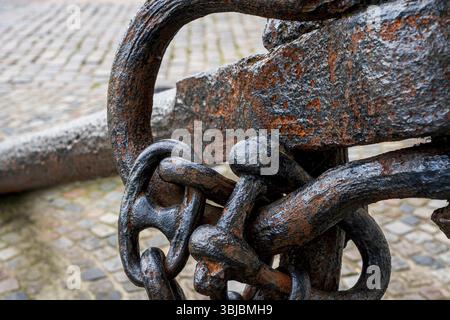 Old rusty anchor chain on the street, Germany, Europe Stock Photo