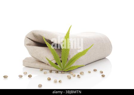 Hemp cloth production, cloth with cannabis leaf and seeds, isolated on white background Stock Photo
