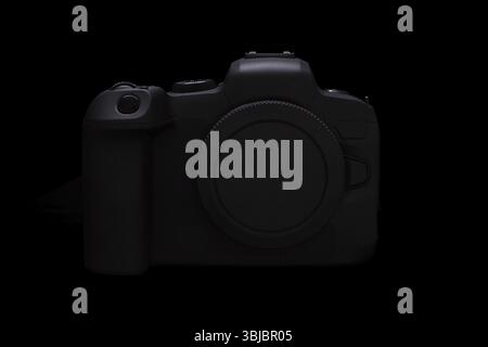 Generic mirrorless digital camera isolated on black background. No brand, mockup, OEM product Stock Photo
