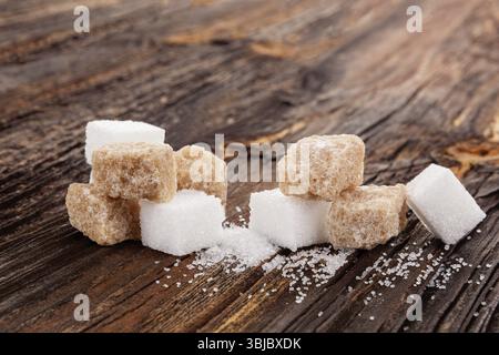 Brown and white crystal sugar cubes on wooden table Stock Photo