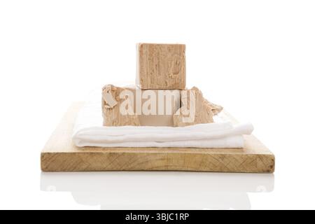 Yeast blocks on wooden board isolated on white background Stock Photo
