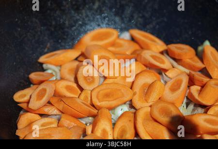 Carrot is cooked in cauldron on fire. Step by step cooking of Chorba Stock Photo