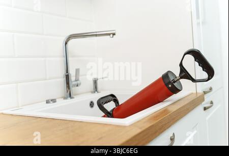 Professional force pump cleaner in the kitchen sink Stock Photo