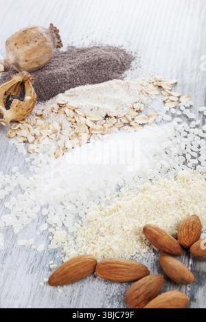Various types of flours. Almond, rice, oat and poppyhead flour on wooden table Stock Photo