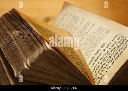 Old antique book open on wooden background Stock Photo