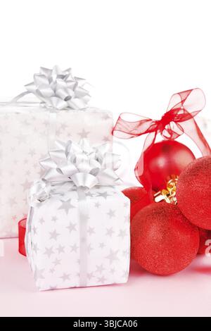 Luxurious christmas background. Red balls and beautifully wrapped presents Stock Photo