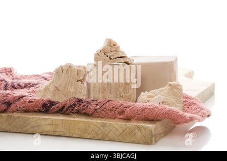 Fresh yeast blocks on wooden board isolated on white background. Traditional baking food ingredient Stock Photo