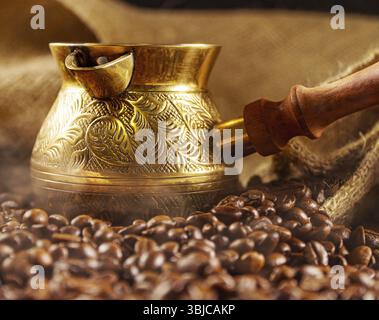 Golden cezve with freshly roasted coffee Stock Photo