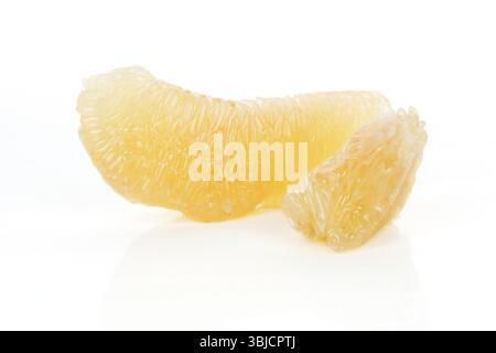 Two peeled pomelo pieces isolated on white background. Tasty fresh fruit eating concept Stock Photo