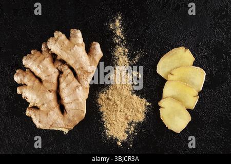 Fresh and ground ginger root spice on black background. Natural remedy Stock Photo