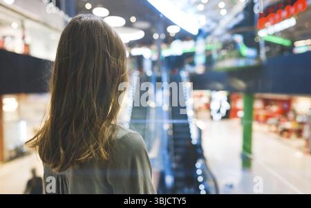 Girl in lift in a large shopping center Stock Photo