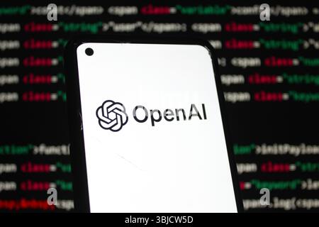 OpenAI logo displayed on a smartphone screen, With code background depicting artificial intelligence. Indonesia - May 27, 2025 Stock Photo