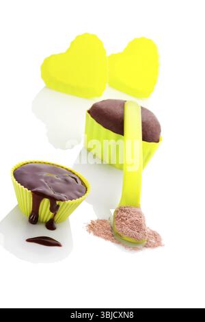 Cupcake chocolate mixture in neon green colored baking forms isolated on white background. Culinary cupcakes baking Stock Photo