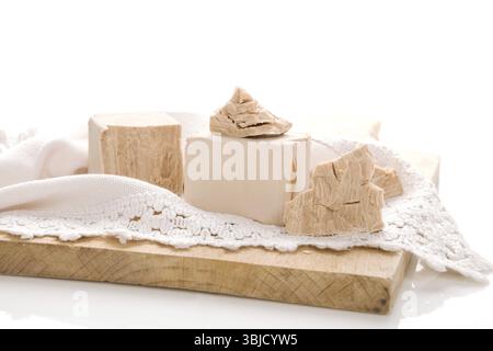 Fresh yeast blocks on wooden board isolated on white background Stock Photo