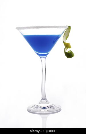 Delicious blue creamy cocktail in cocktail glass isolated on white background. Decorated with lime garnish Stock Photo