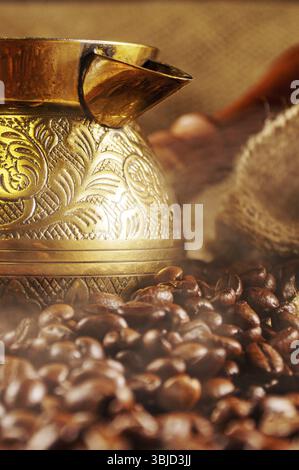 Golden cezve with freshly roasted coffee Stock Photo