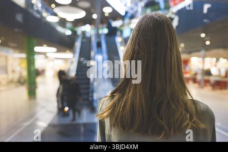 Girl in lift in a large shopping center Stock Photo