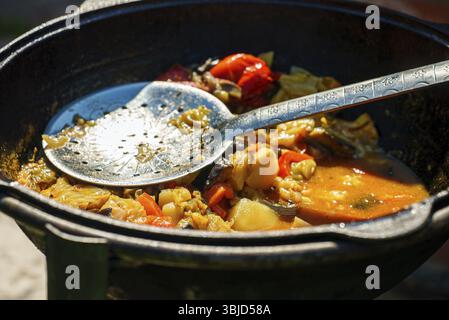 Vegetable Chorba in cauldron on fire Stock Photo