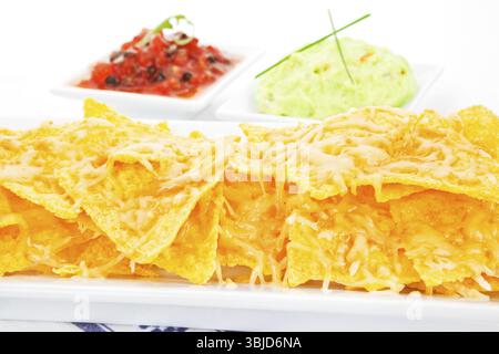 Delicious nachos baked with cheese close up Stock Photo