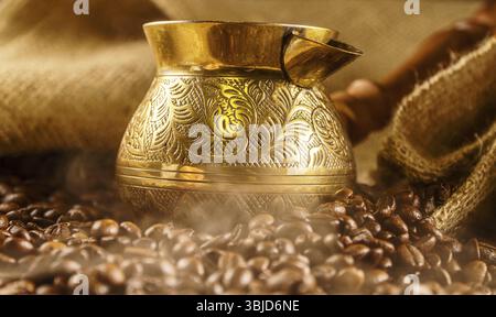 Golden cezve with freshly roasted coffee Stock Photo